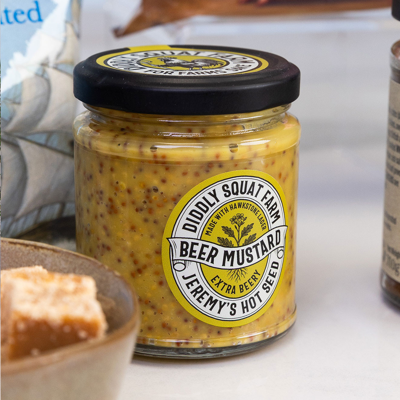 Jar of Diddly Squat Farm Jeremy's Hot Seed Beer Mustard made with Hawkstone Lager, ideal for pairing with cheeses, meats and sandwiches.