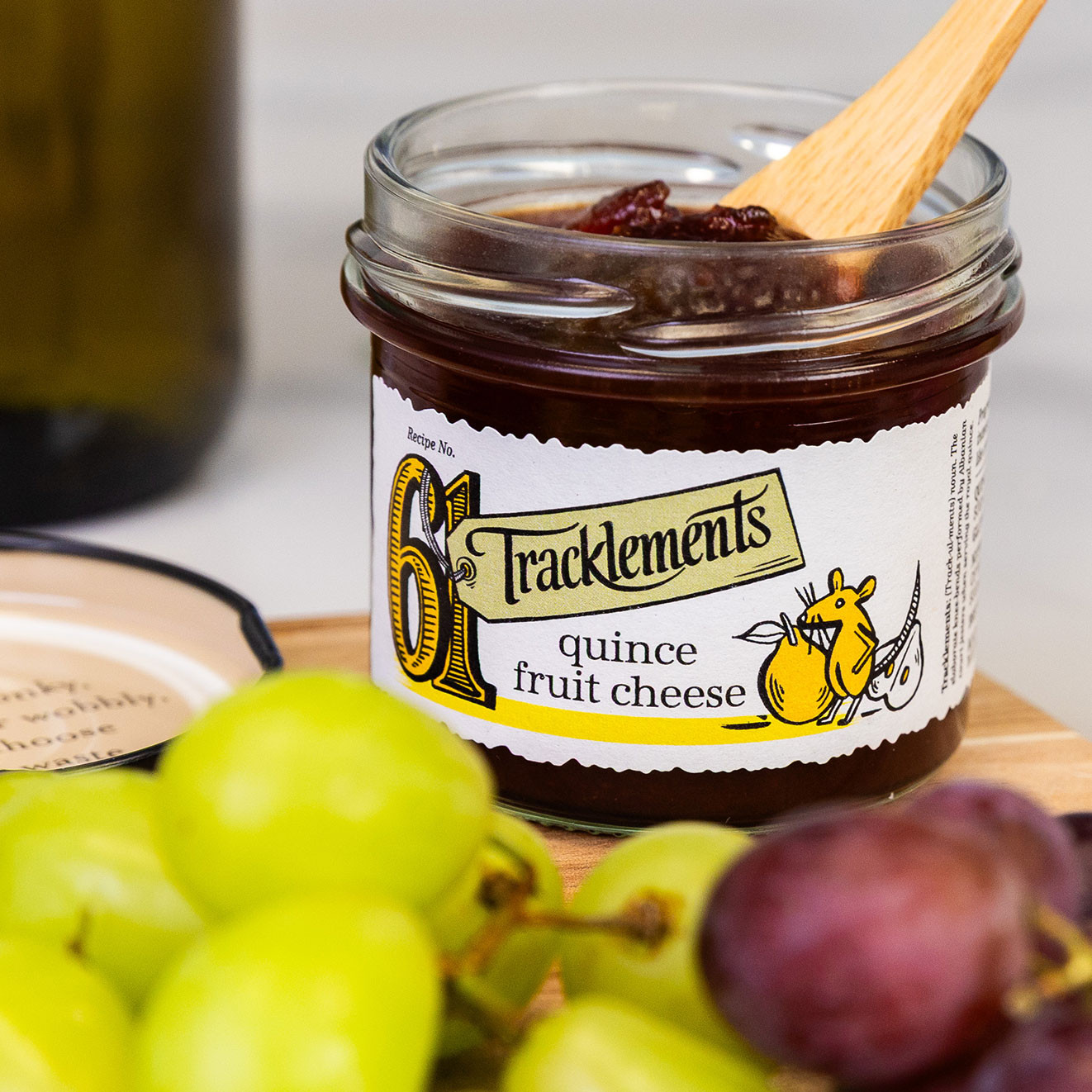 Open jar of Tracklements Quince Fruit Cheese, a rich fruity accompaniment designed to complement mature cheeses and crackers.