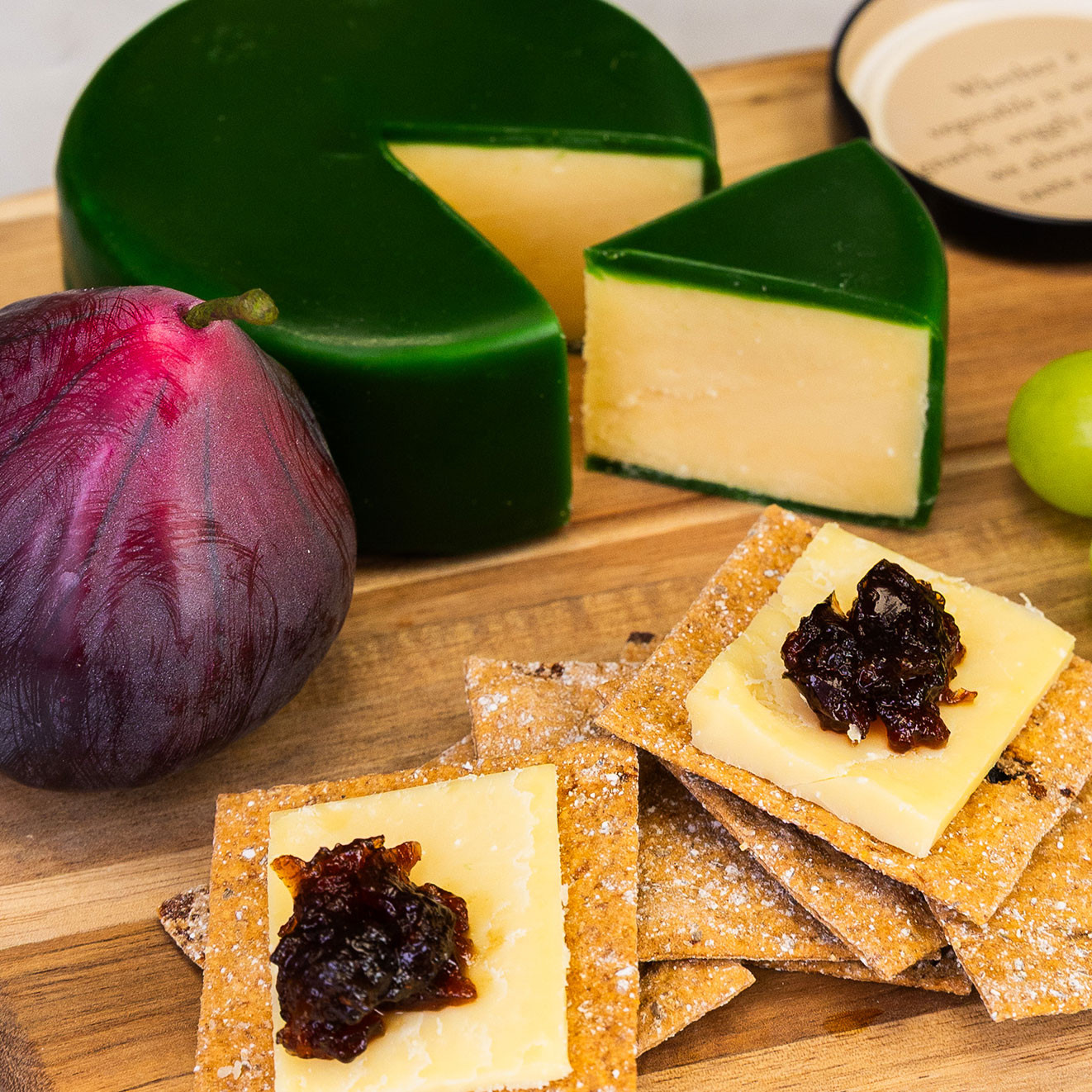 Artisan cheese served with rye sourdough crackers and Tracklements quince fruit cheese, creating a classic sweet and savoury cheeseboard pairing.