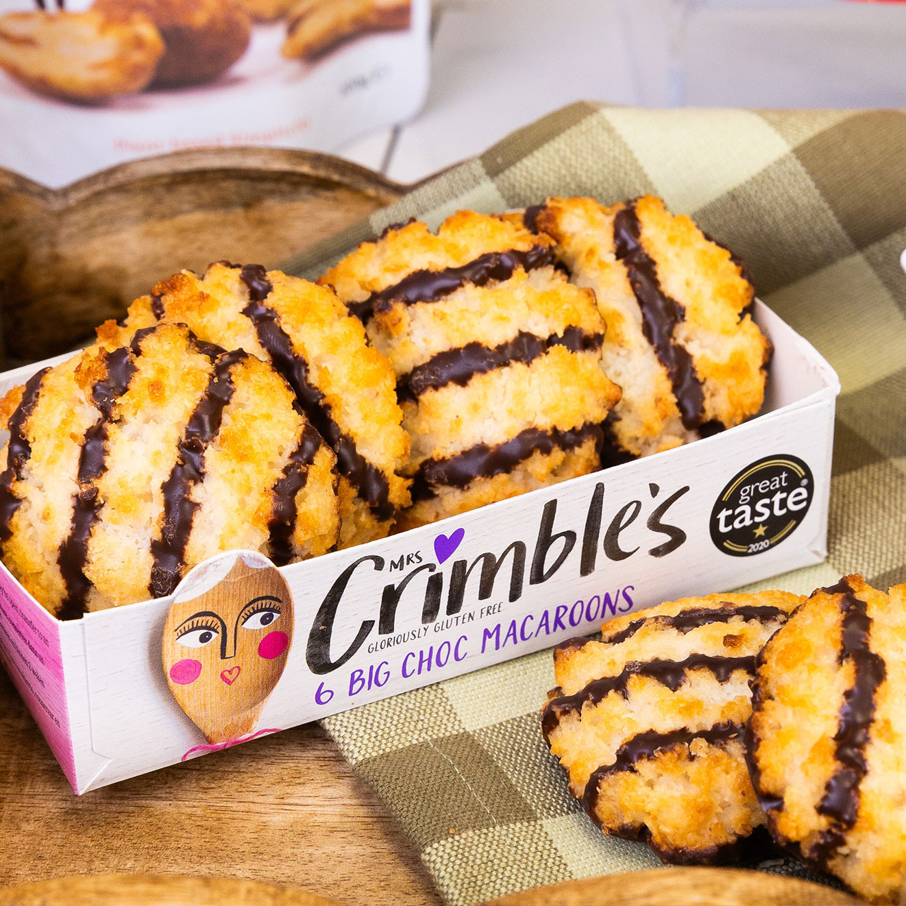Mrs Crimble's gluten-free Big Choc Macaroons with rich dark chocolate drizzle, presented in an open carton ready to enjoy.