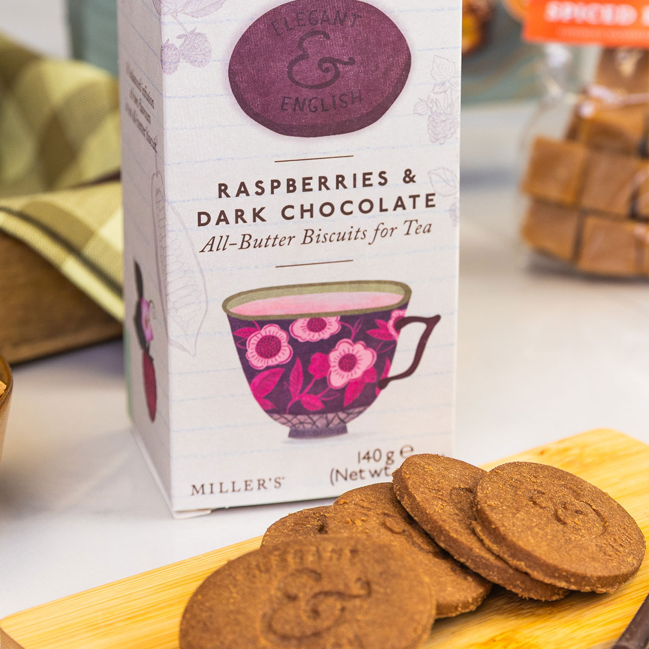 Miller's Elegant & English all-butter biscuits with raspberry and dark chocolate, served alongside crisp chocolate biscuits for an indulgent tea break.