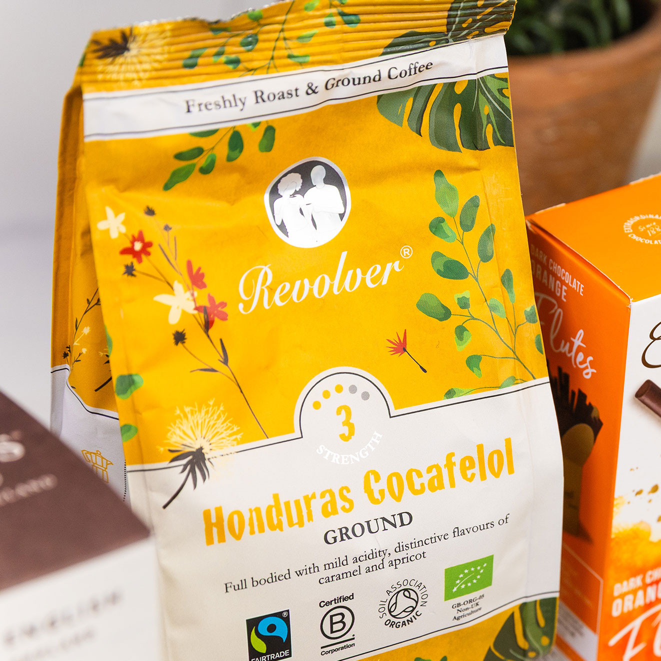 Bag of Revolver Honduras Cocafelol ground coffee, a Fairtrade organic medium-strength roast with notes of caramel and apricot, perfect for cafetière brewing.