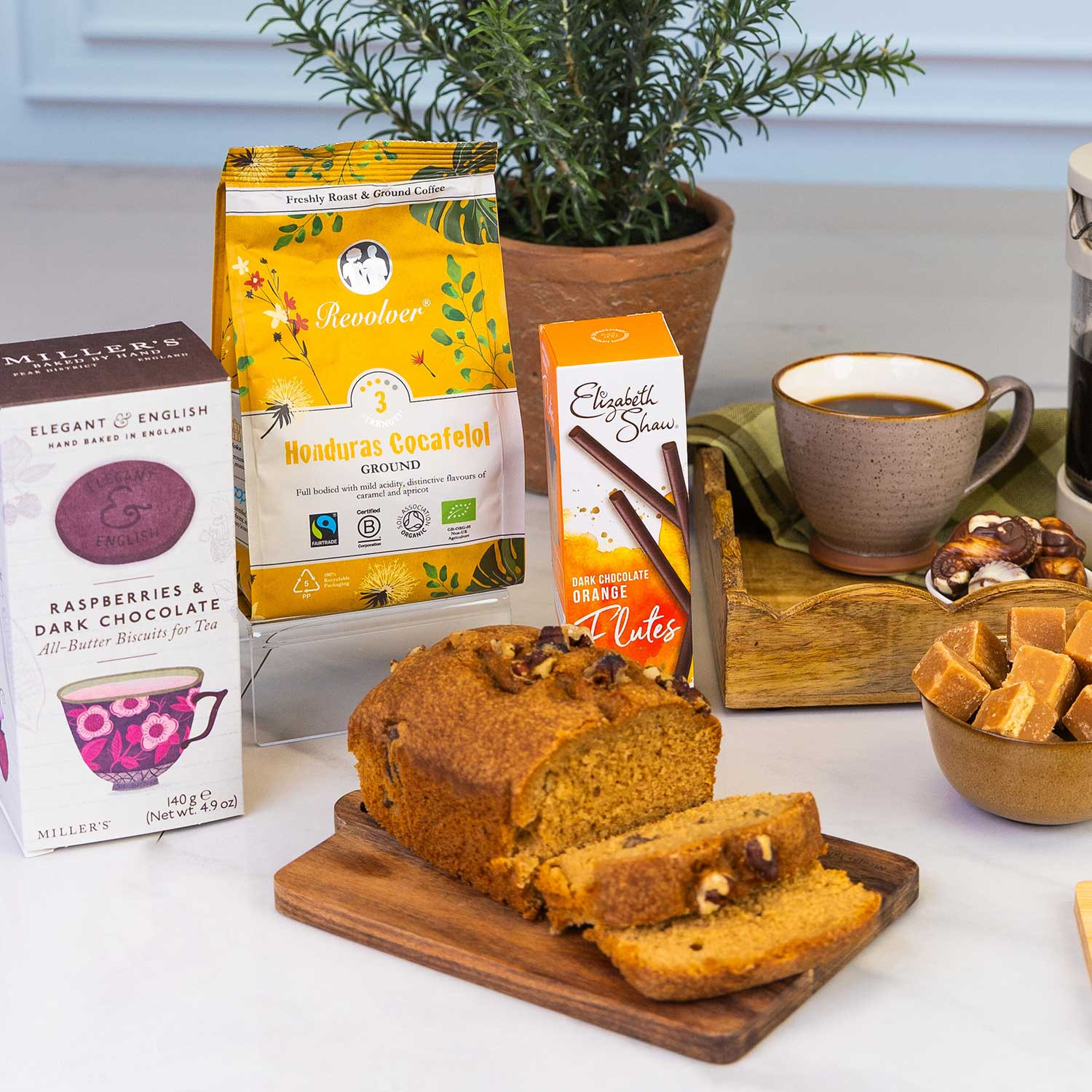 Close up of the Coffee and chocolate gift hamper featuring premium ground coffee, Belgian chocolates, artisan fudge, breakfast tea, biscuits and sweet treats, styled around a cafetière for cosy moments.