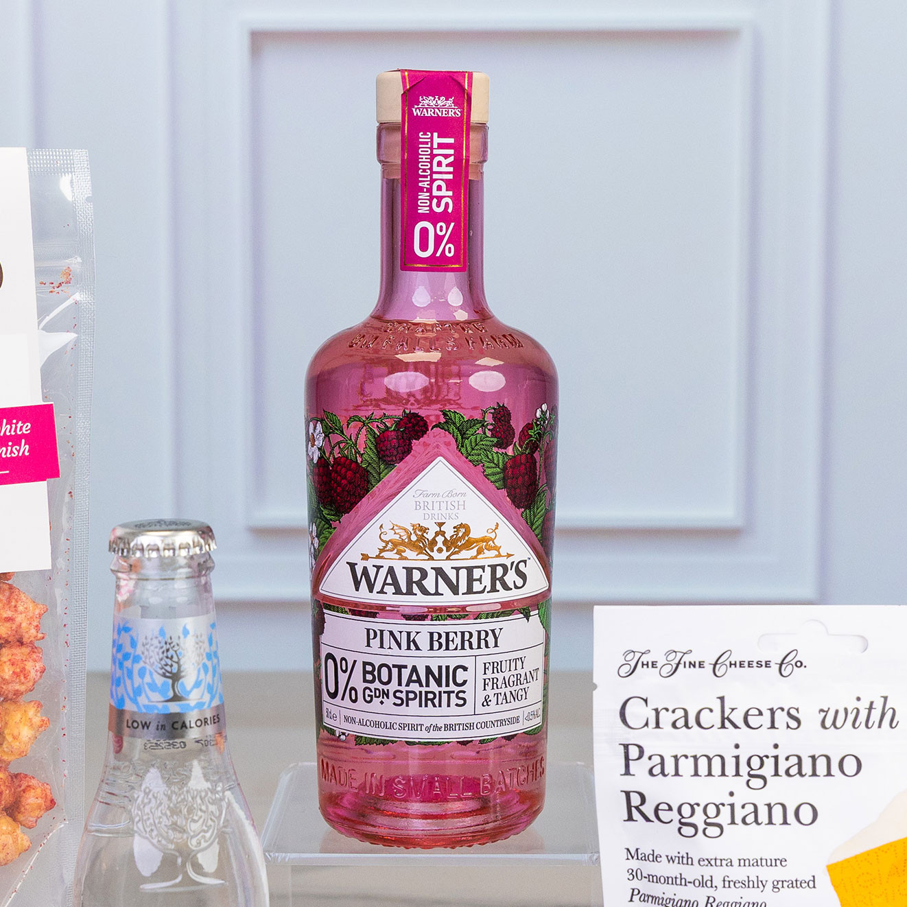-Bottle of Warner's Pink Berry 0% botanical spirit, a fruity, fragrant alcohol-free alternative infused with berry botanicals for refreshing mixed drinks.