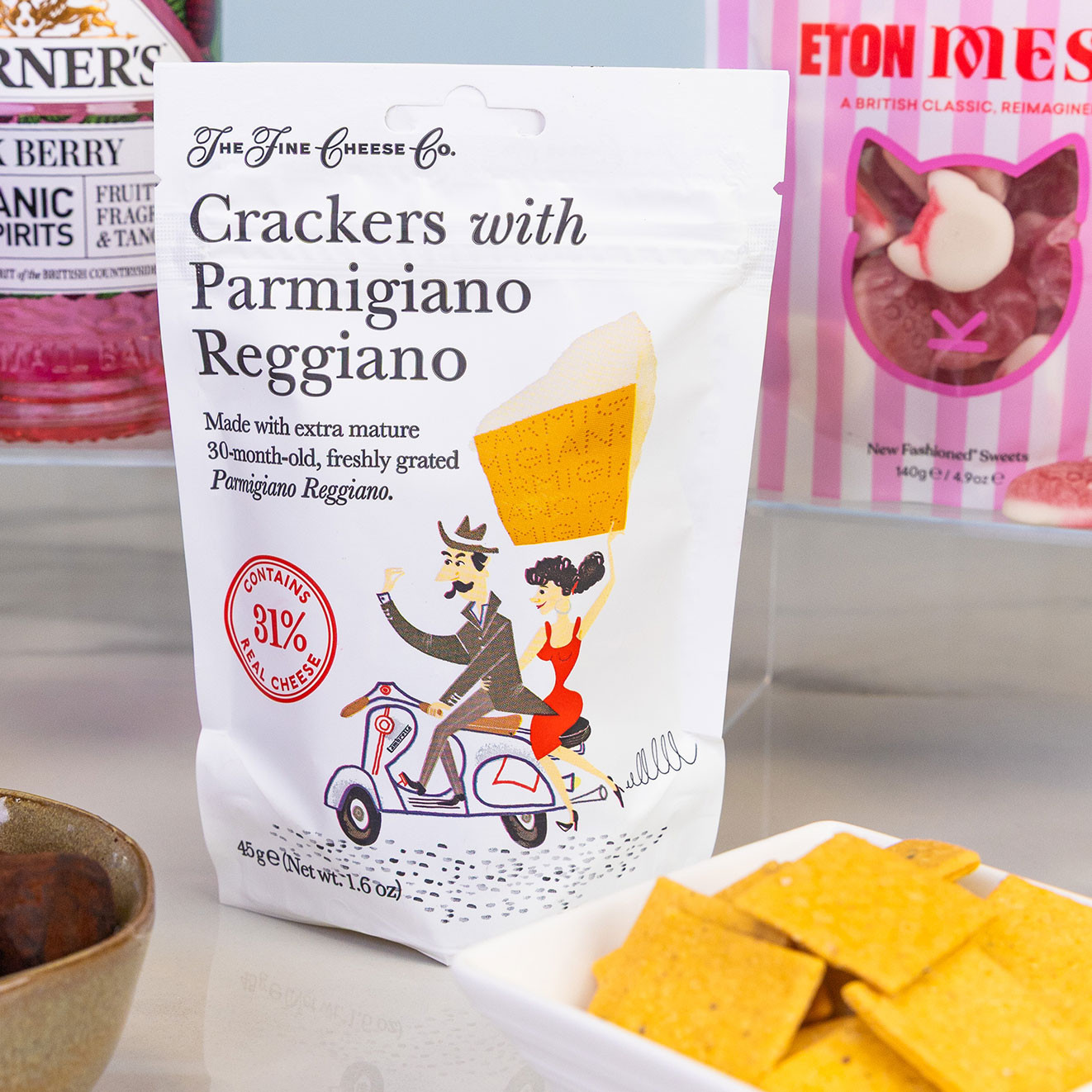 The Fine Cheese Co. crackers with Parmigiano Reggiano, crisp savoury crackers made with aged Italian cheese and served alongside bite-sized cheese biscuits.
