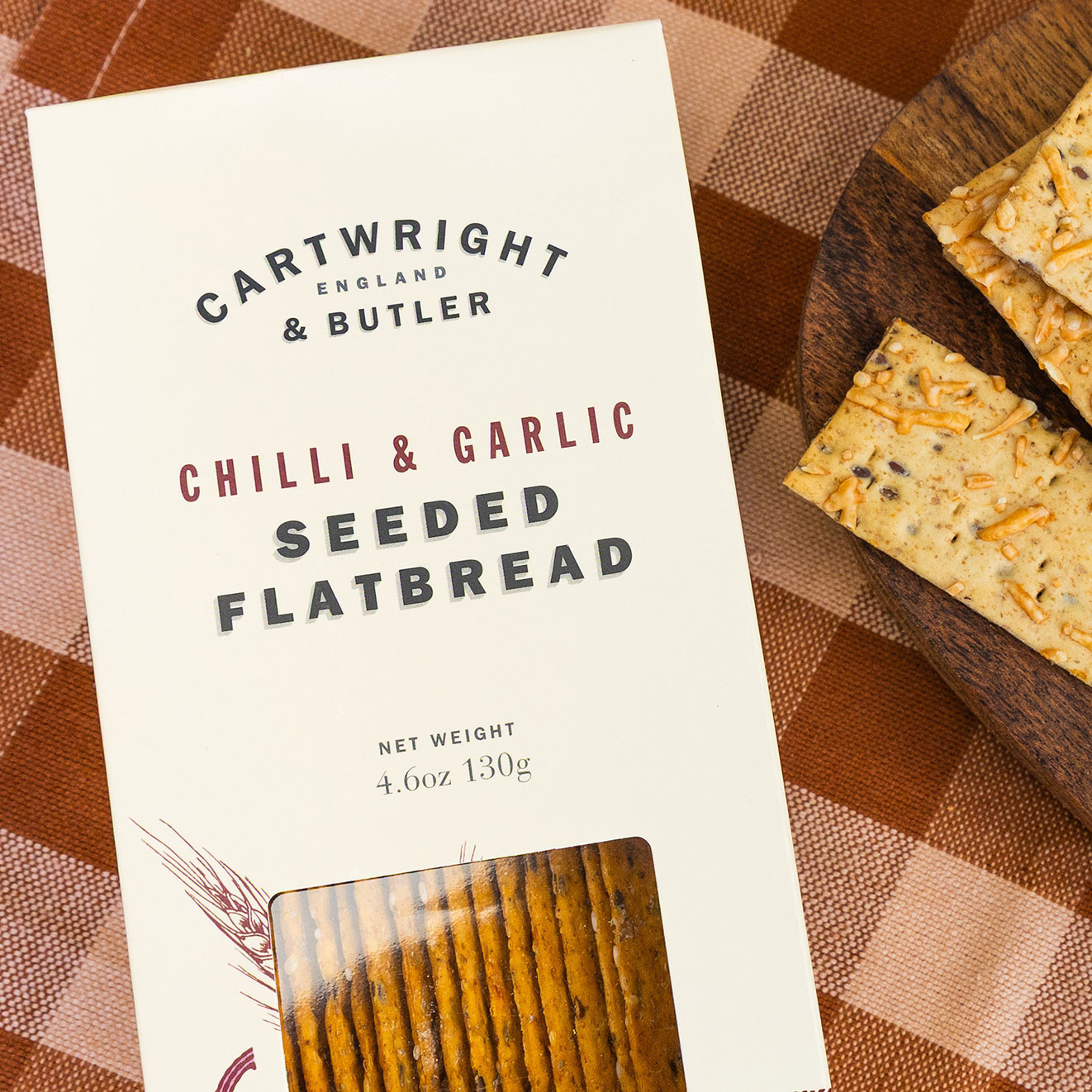 Box of Cartwright & Butler Chilli & Garlic Seeded Flatbread with crisp seeded crackers, ideal for pairing with dips, cheese and savoury accompaniments.