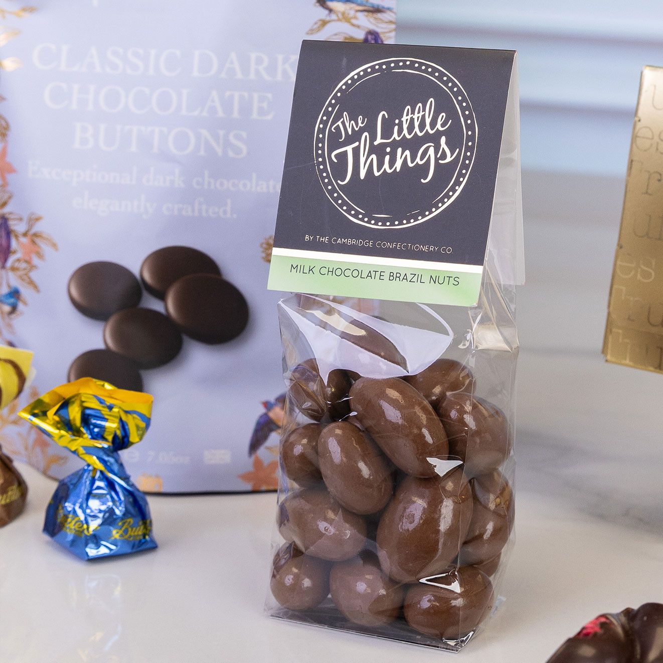 Bag of The Little Things milk chocolate Brazil nuts, featuring whole Brazil nuts coated in smooth milk chocolate for a luxurious sweet treat.