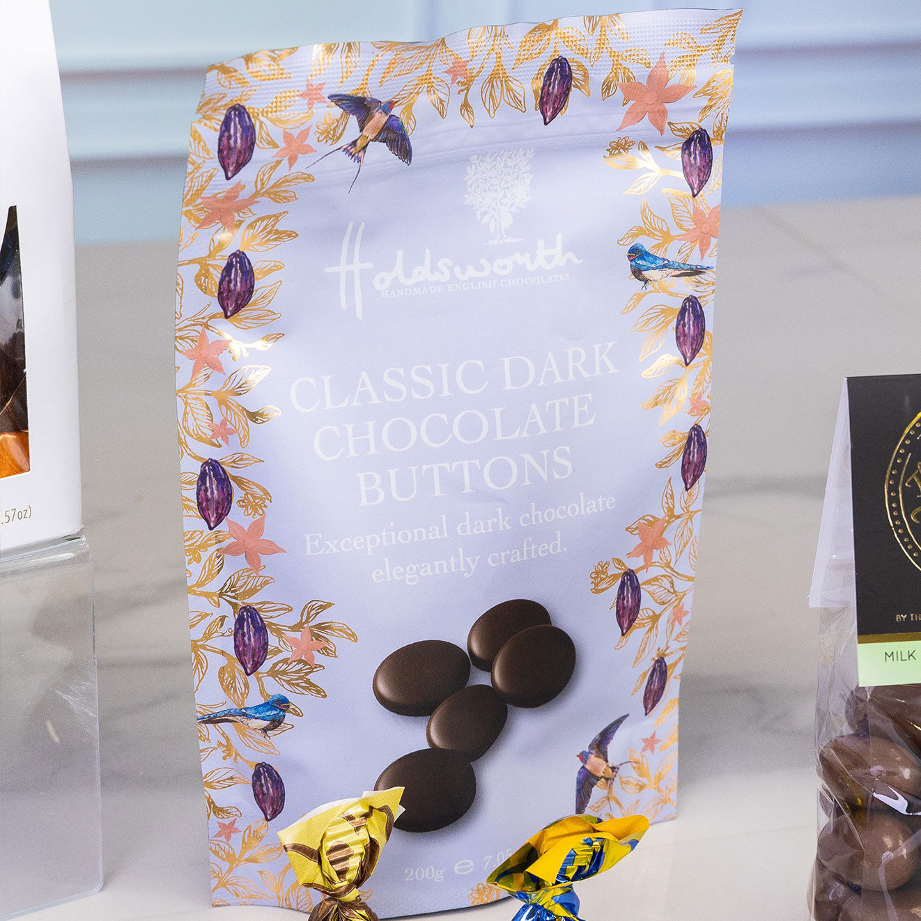 Pouch of Holdsworth Classic Dark Chocolate Buttons filled with rich, handcrafted dark chocolate discs, beautifully packaged for gifting and indulgence.