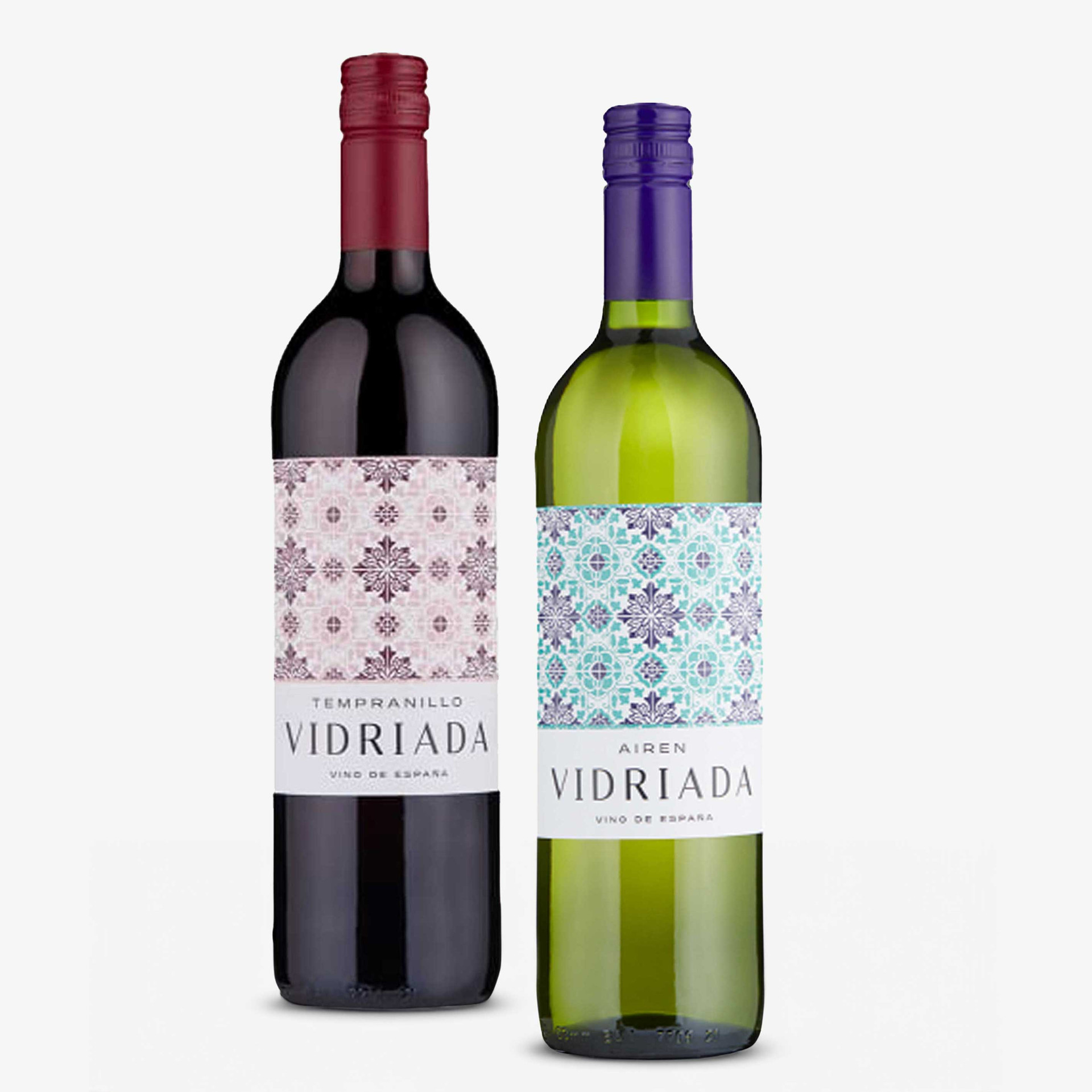 Two Vidriada Spanish wines: a Tempranillo red wine in a dark bottle with burgundy screw cap, and an Airén white wine in a green bottle with purple screw cap, both featuring decorative patterned labels.