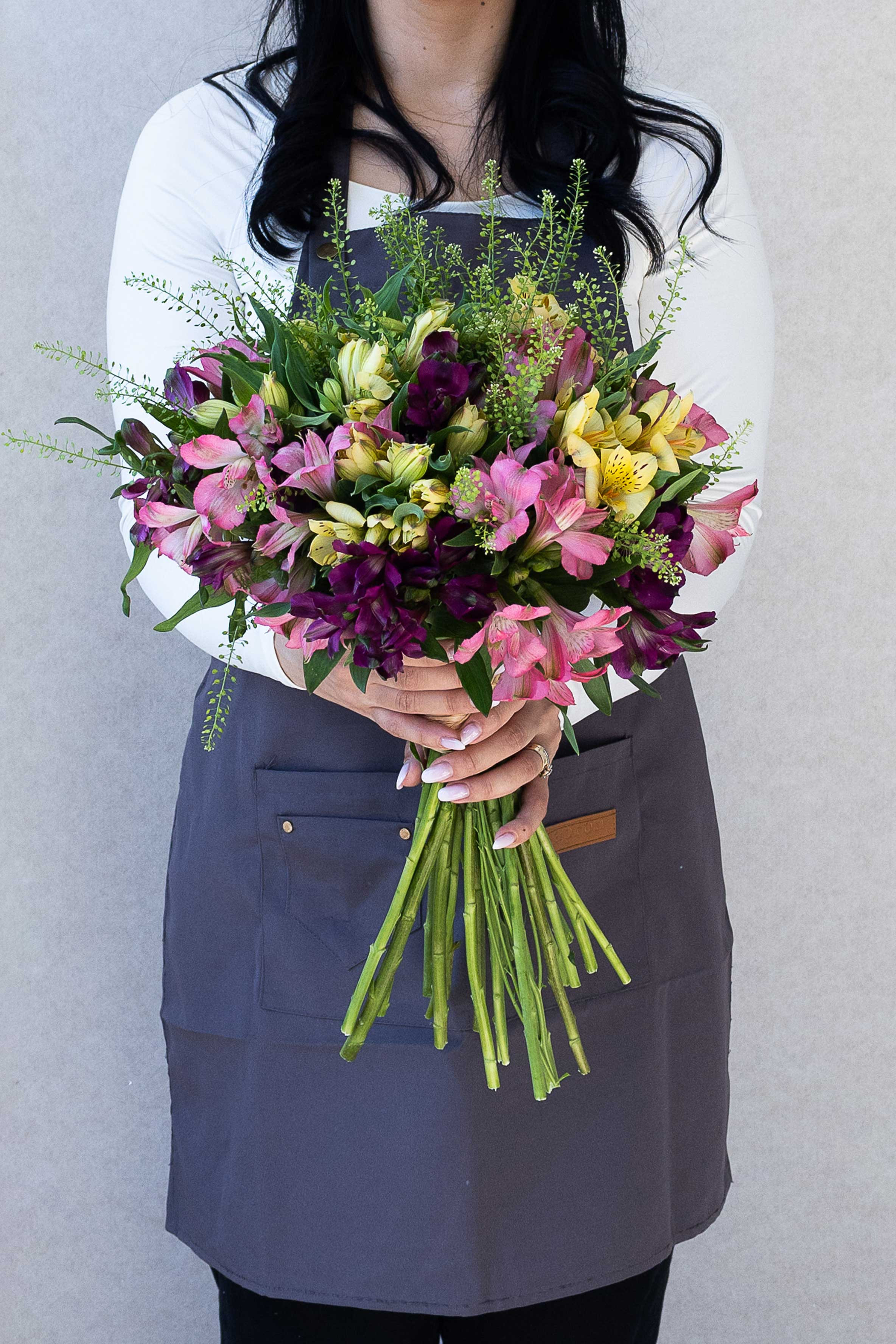 Colourful alstroemeria bouquet in pink, burgundy, and pale yellow tones.