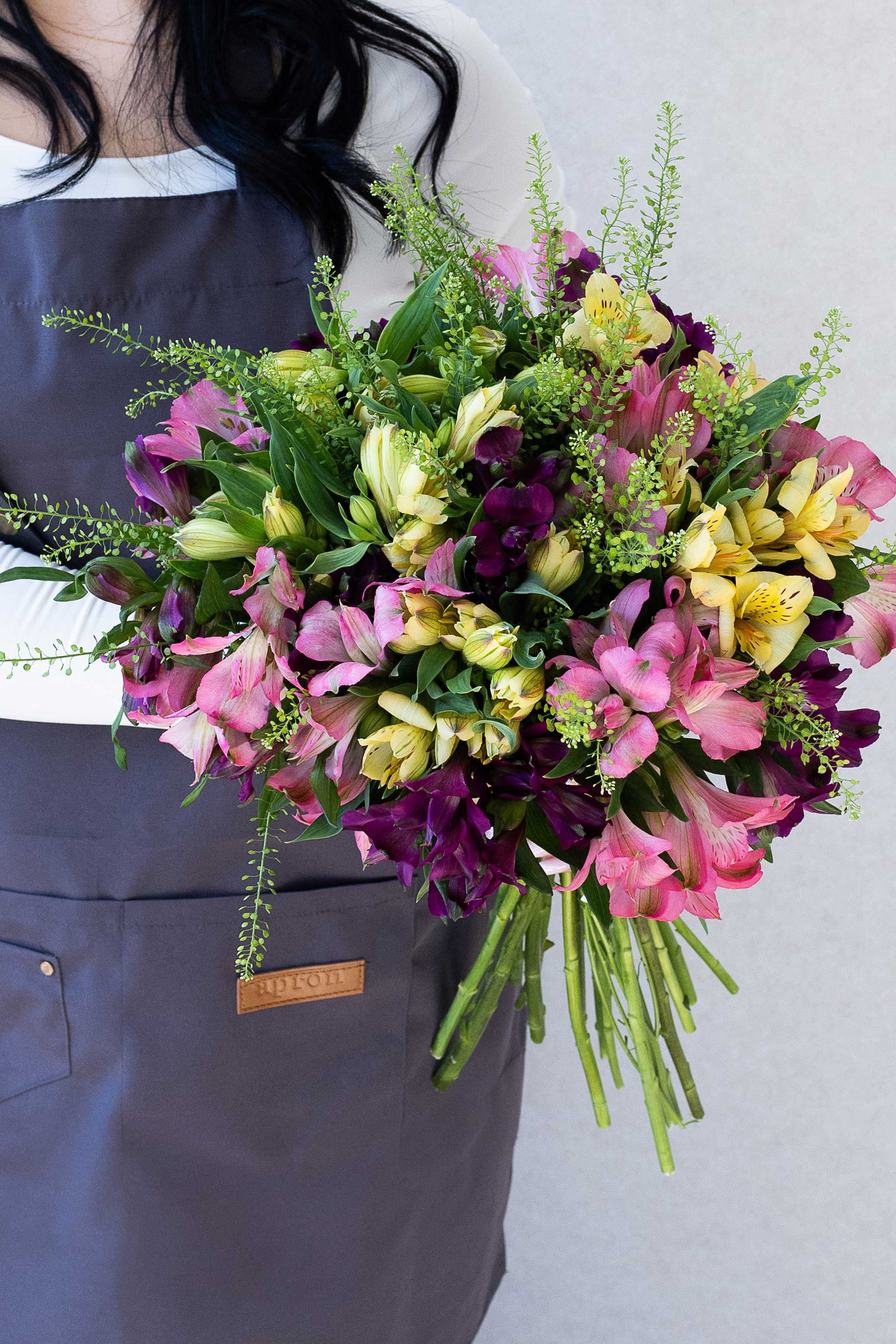 Bright mixed alstroemeria bouquet with pink, burgundy, and yellow flowers.