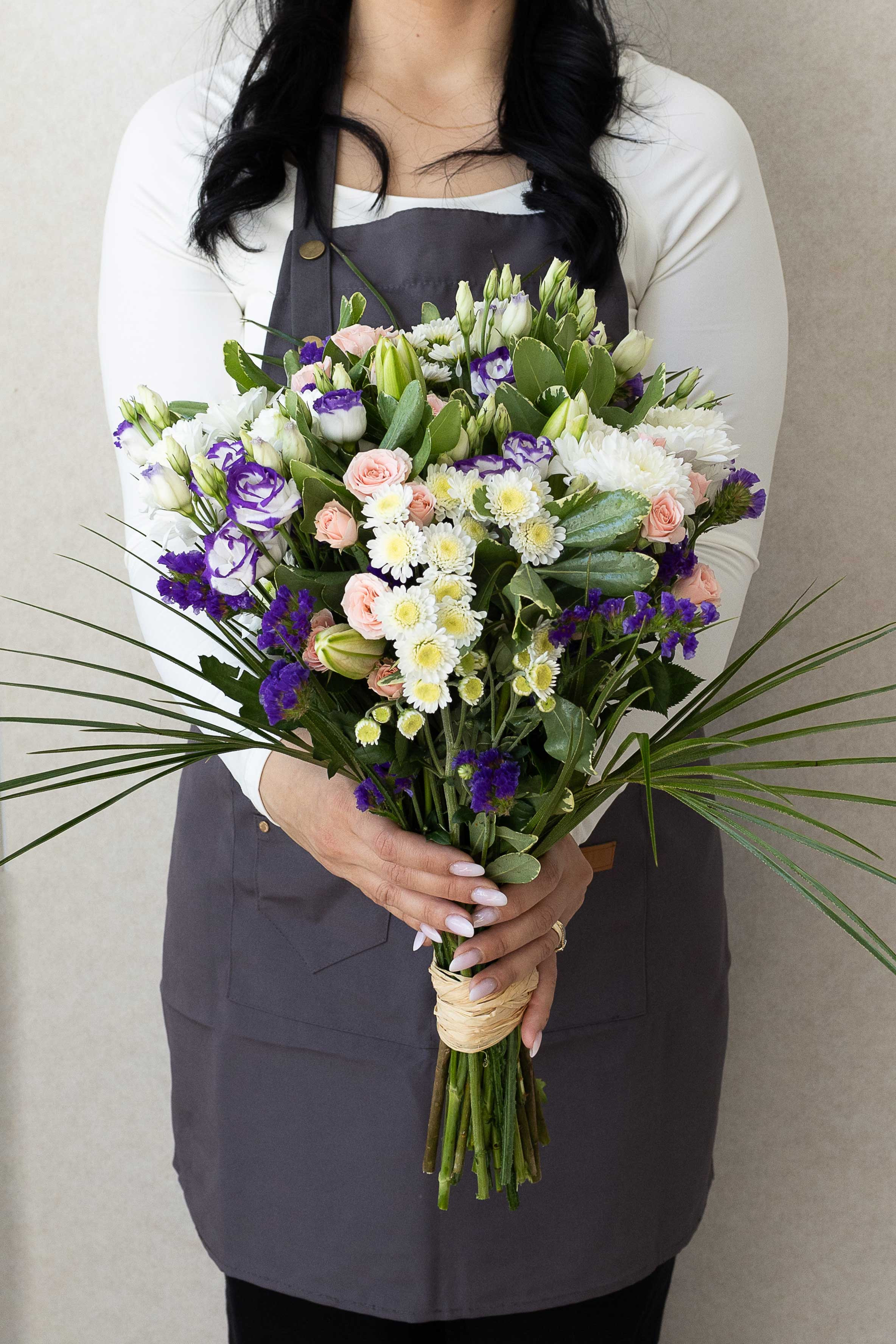 Pastel pink, white, and purple bouquet with lisianthus, roses, and chrysanthemums.