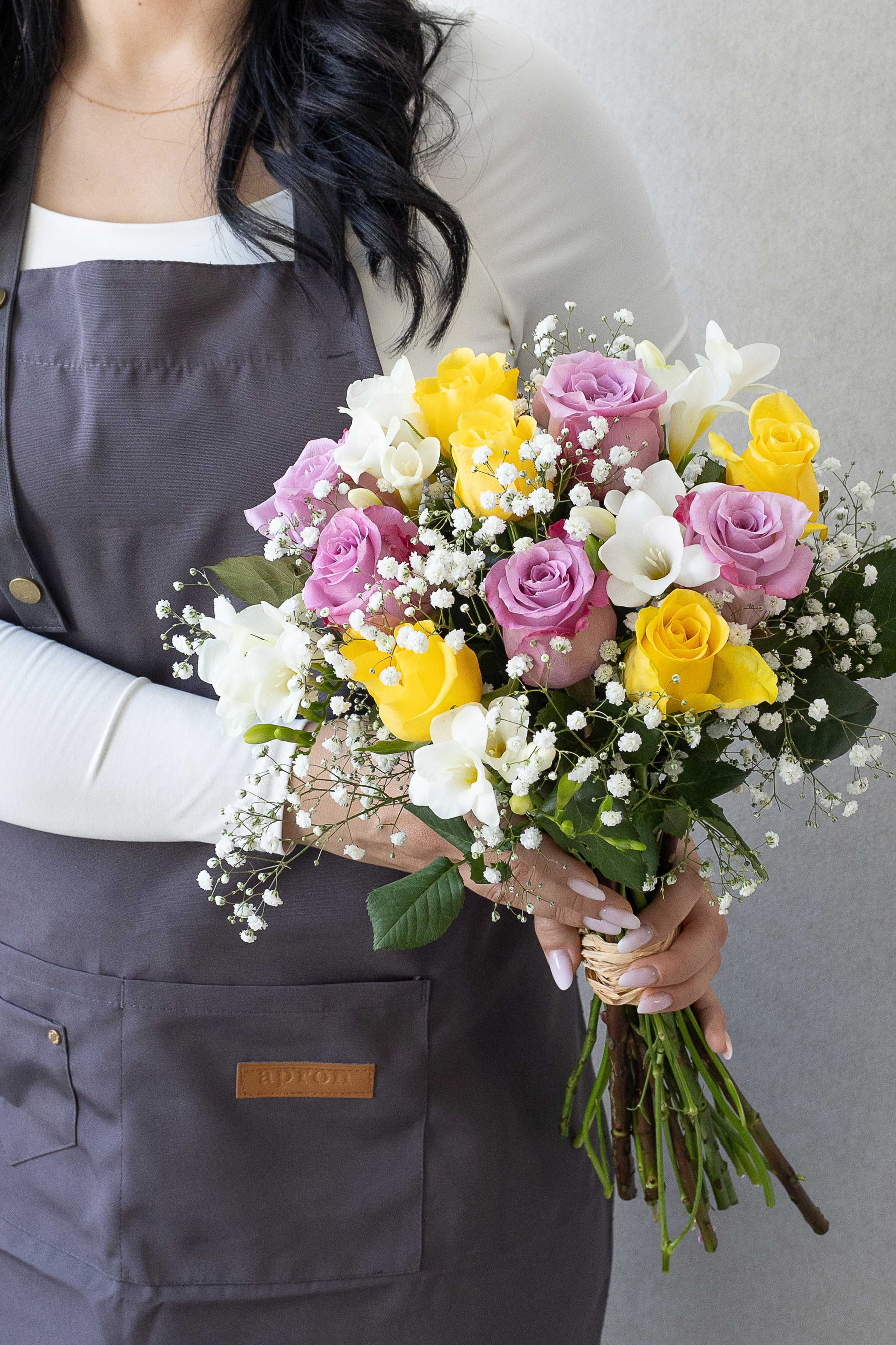 Lavender and yellow rose bouquet with white freesias.