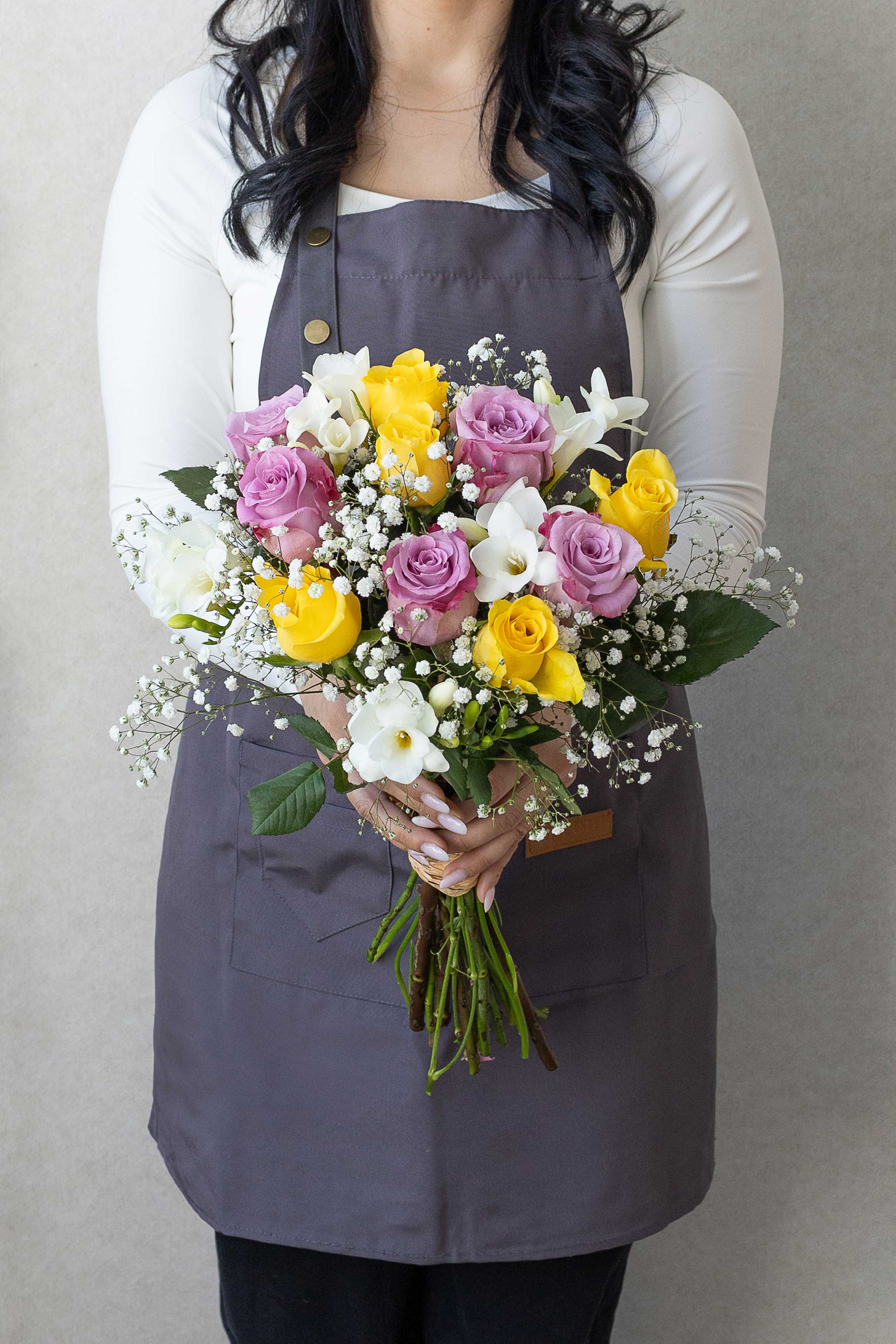 Elegant bouquet of lavender roses, yellow roses and freesias.