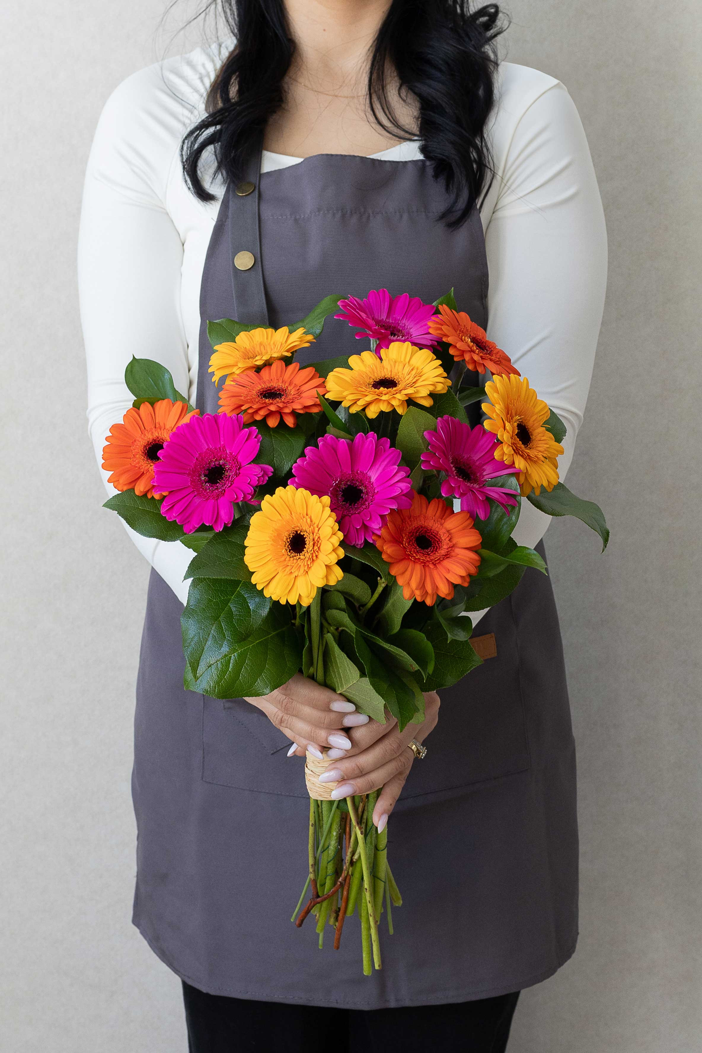 Colourful gerbera bouquet with pink, orange, and yellow blooms.