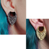 SoScene Black Artisan filigree stainless steel saddle spreaders, image of black and gold earrings with intricate filigree design worn on ears with vibrant blue hair.
