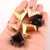 SoScene Geometric saddle spreader plugs, assorted metallic and black geometric jewelry accessories in a hand.