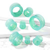SoScene Green Opalite Glass Double Flared Saddle Tunnel, a set of hollow, translucent green opalite glass body jewelry tunnels with a double flared design for piercing accessories.