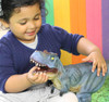 girl playing with our blue T-rex toy dinosaur