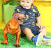 child playing with a jumbo soft feel red T-Rex toy