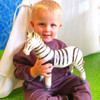 boy holding our jumbo toy zebra