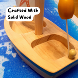 Wooden sailboat crafted from solid wood with a smooth finish, ideal for children's imaginative play.