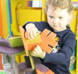 child playing with our U-Nu 140 piece eco-friendly colourful wooden natural building and construction set