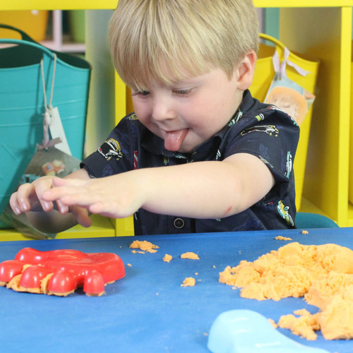 Child playing with kinetic sand