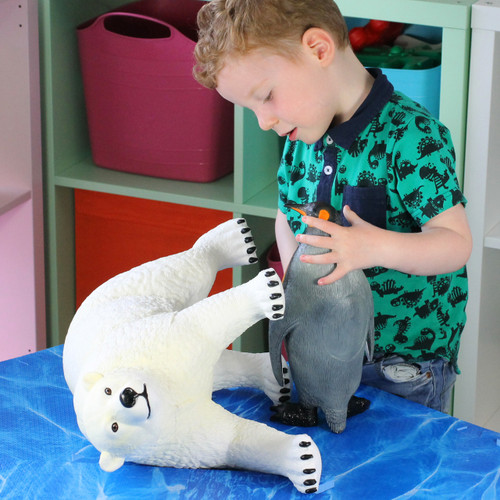 Child playing with the jumbo polar bear play figure