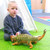 boy playing with 2 jumbo large dinosaur toys - a 21-inch spinosaurus and a 21-inch ankylosaurus