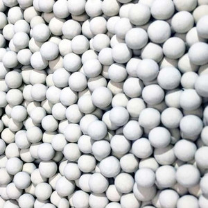 Close up photo of many activated alumina 3/16" white beads.