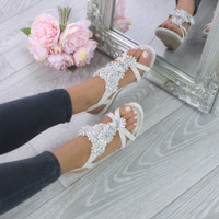 Model wearing Beige PU Low Mid Wedge Heel Flower Diamante T-Bar Slingback Sandals