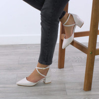 Model wearing Nude PU Mid Block Heel Cross Strap Two Part Ankle Strap Shoes