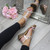 Model wearing Rose Gold PU Low Mid Wedge Heel T-Bar Flower Diamante Sandals
