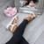 Model wearing White PU Low Wedge Heel Comfort Flatform Diamante Flower T-Bar Slingback Sandals Model wearing White PU Low Wedge Heel Comfort Flatform Diamante Flower T-Bar Slingback Sandals