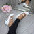 Model wearing White Patent Mid Heel Mary Jane Court Shoes Model wearing White Patent Mid Heel Mary Jane Court Shoes
