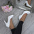 Model wearing White Patent High Heel Platform Court Shoes Model wearing White Patent High Heel Platform Court Shoes