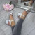 Model wearing Silver Satin Mid Block Heel Ankle Strap Barely There Sandals Model wearing Silver Satin Mid Block Heel Ankle Strap Barely There Sandals