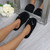 Model wearing Black Flat Fleece Fluffy Mules Slippers