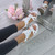 Model wearing White PU Low Mid Wedge Heel Flower Diamante T-Bar Slingback Sandals