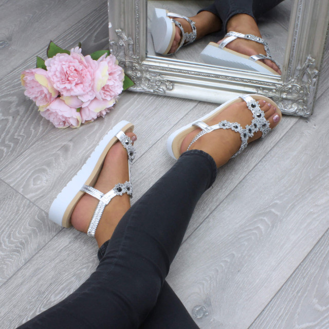 Model wearing Silver PU Low Wedge Heel Comfort Flatform Diamante Flower T-Bar Slingback Sandals