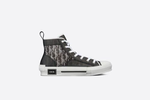 The B23 high-top sneaker superimposes transparent mesh inserts with black and white Dior Oblique-printed canvas for a standout effect. Set apart by modern design details, the shoe maintains timeless sneaker codes such as eyelets and a lace-up front, a white rubber sole, a reinforced round toe, and a rear heel tab. The sneaker is further enhanced with contrasting details on the sides, including a 'DIOR' signature. It will pair easily with any casual outfit.