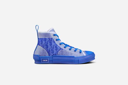 The B23 high-top sneaker is set apart by its layering of transparent paneling and blue Dior Oblique canvas. Essential details, such as eyelets and a lace-up front, a blue rubber sole, a rounded and reinforced toe as well as a rear tab recall the codes of the classic high-top style. The sneaker is further enhanced with tonal details on the sides, as well as a contrasting 'DIOR' signature, and pairs easily with any casual outfit.