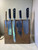 Magnetic knife block in dark reclaimed hardwood, holding five Damascus-blade chef’s knives