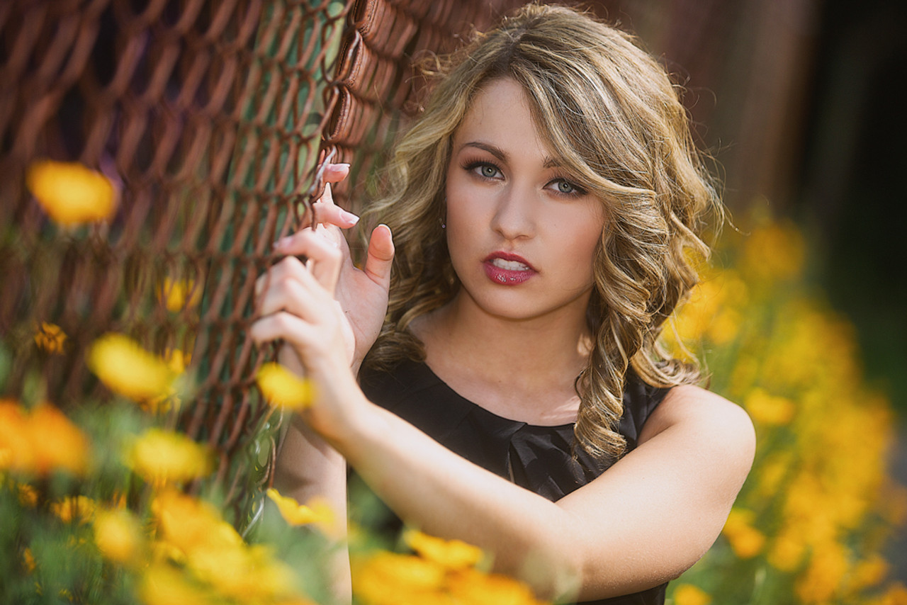 A beautiful young girl poses for a fashion style portrait outdoors at a  park with natural lighting Stock Photo - Alamy