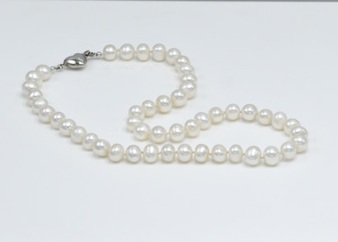 A timeless classic freshwater pearl necklace with sterling silver heart clasp A timeless classic freshwater pearl necklace with sterling silver heart clasp