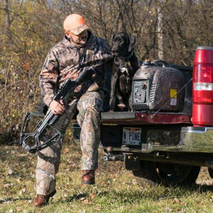 Westinghouse iGen2200Camo Inverter Generator with TrueTimber Kanati Camo. Man and Dog with Generator