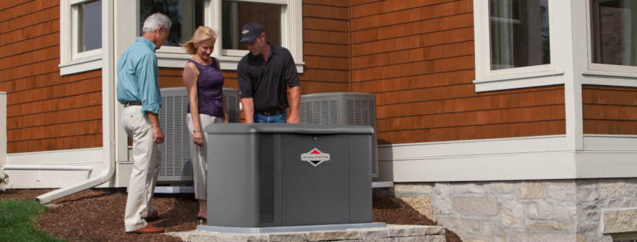 An installer technician shows homeowners their new Briggs and Stratton standby generator.