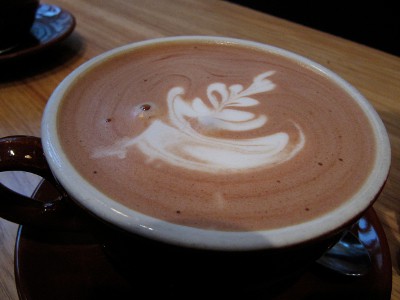 Hot Chocolate in a cup with patterned cream design topping.