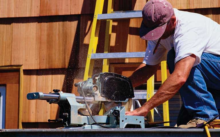 Contractor Using Electric Power Tool on the Job Contractor Using Electric Power Tool on the Job
